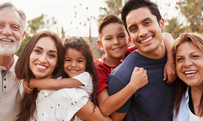 Smiling three generation family with two grandparents, two parents and two young children